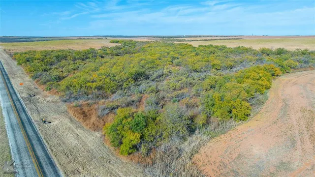 a view of a field with an ocean