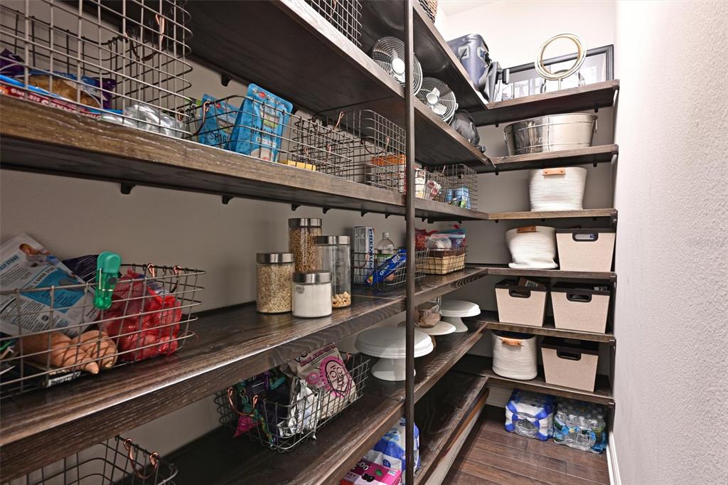 11807 Rive Isle Run Parrish, FL 34219 - Photo 13 of 57 a room with lots of books and a wooden floor