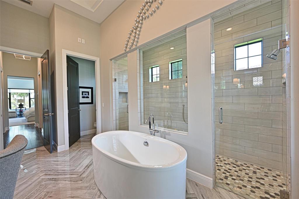 11807 Rive Isle Run Parrish, FL 34219 - Photo 19 of 57 a bathroom with a bathtub and shower