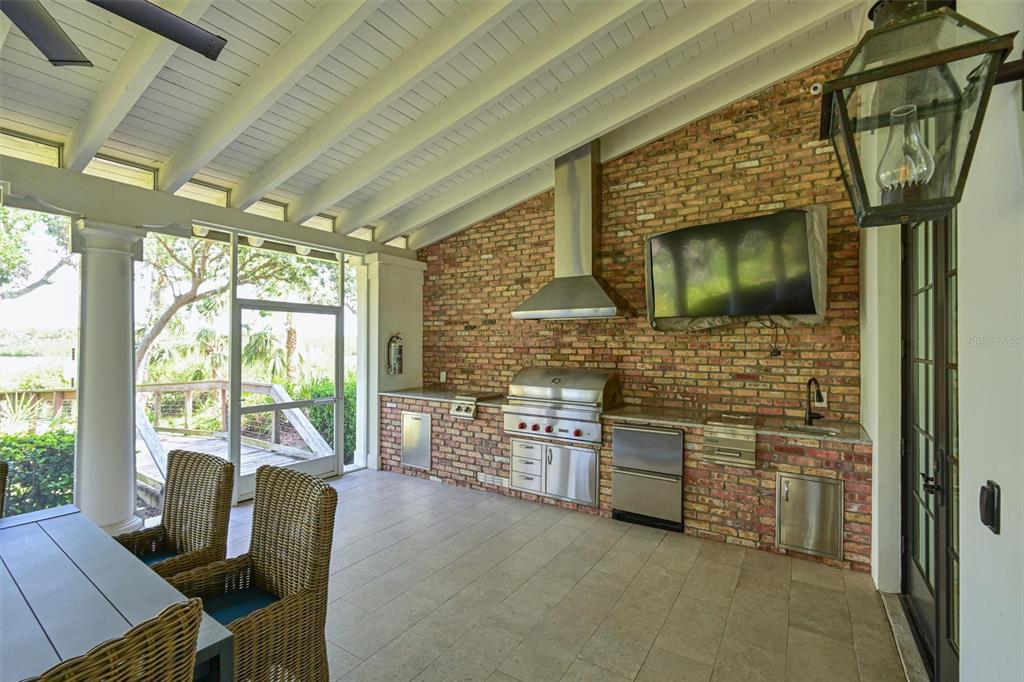 11807 Rive Isle Run Parrish, FL 34219 - Photo 44 of 57 a living room with fireplace furniture and a floor to ceiling window