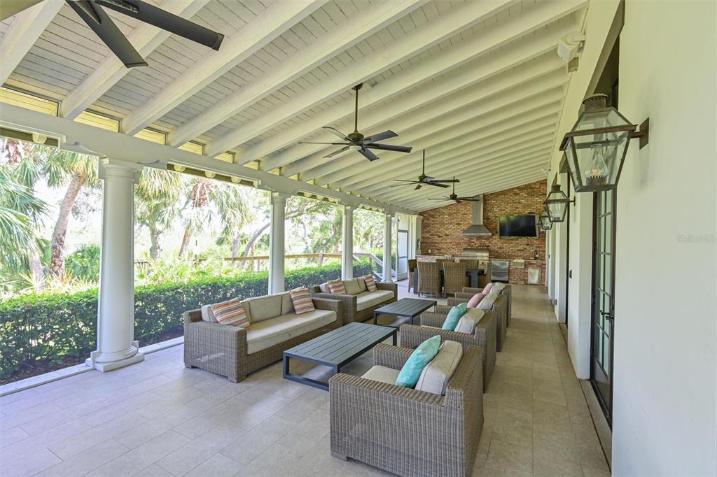 11807 Rive Isle Run Parrish, FL 34219 - Photo 45 of 57 a living room with patio furniture and a floor to ceiling window