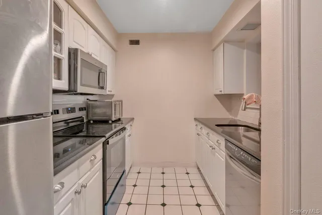 a kitchen with stainless steel appliances granite countertop a stove and a refrigerator