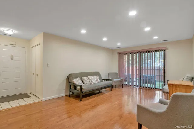 a living room with furniture and a floor to ceiling window