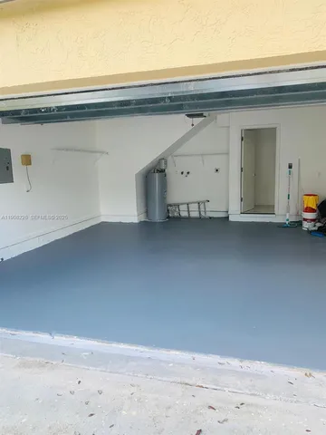 a kitchen with stainless steel appliances kitchen island sink refrigerator and microwave