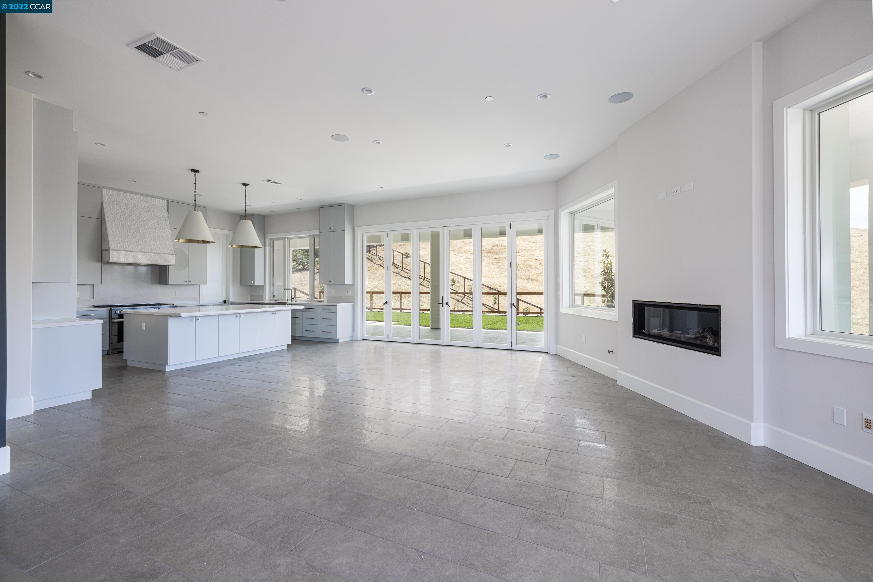 145 Arbor View Lane Lafayette, CA 94549 - Photo 11 of 46 a view of an empty room with a kitchen and a window