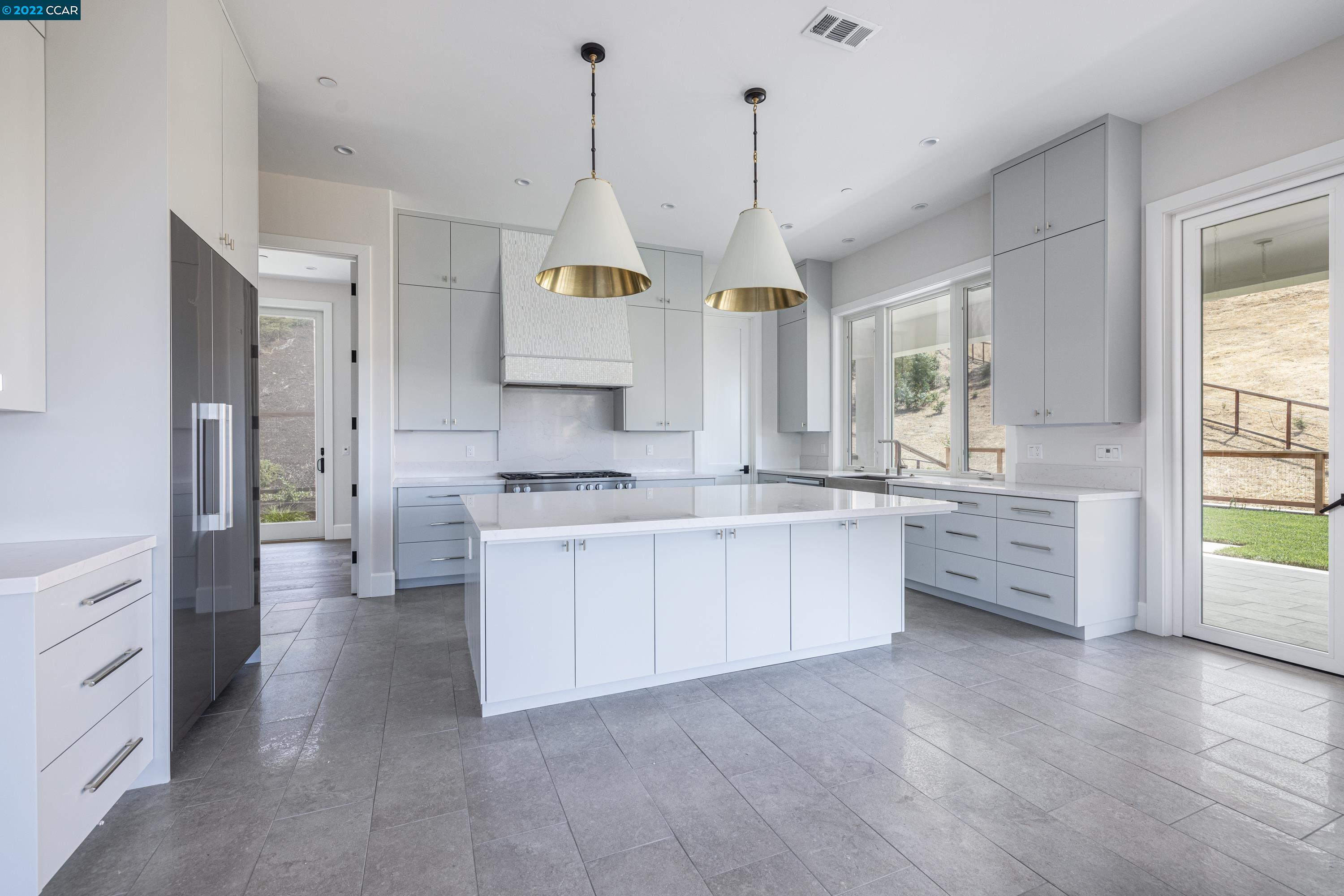 145 Arbor View Lane Lafayette, CA 94549 - Photo 15 of 46 a kitchen with stainless steel appliances kitchen island granite countertop a stove a sink a refrigerator and white cabinets with wooden floor