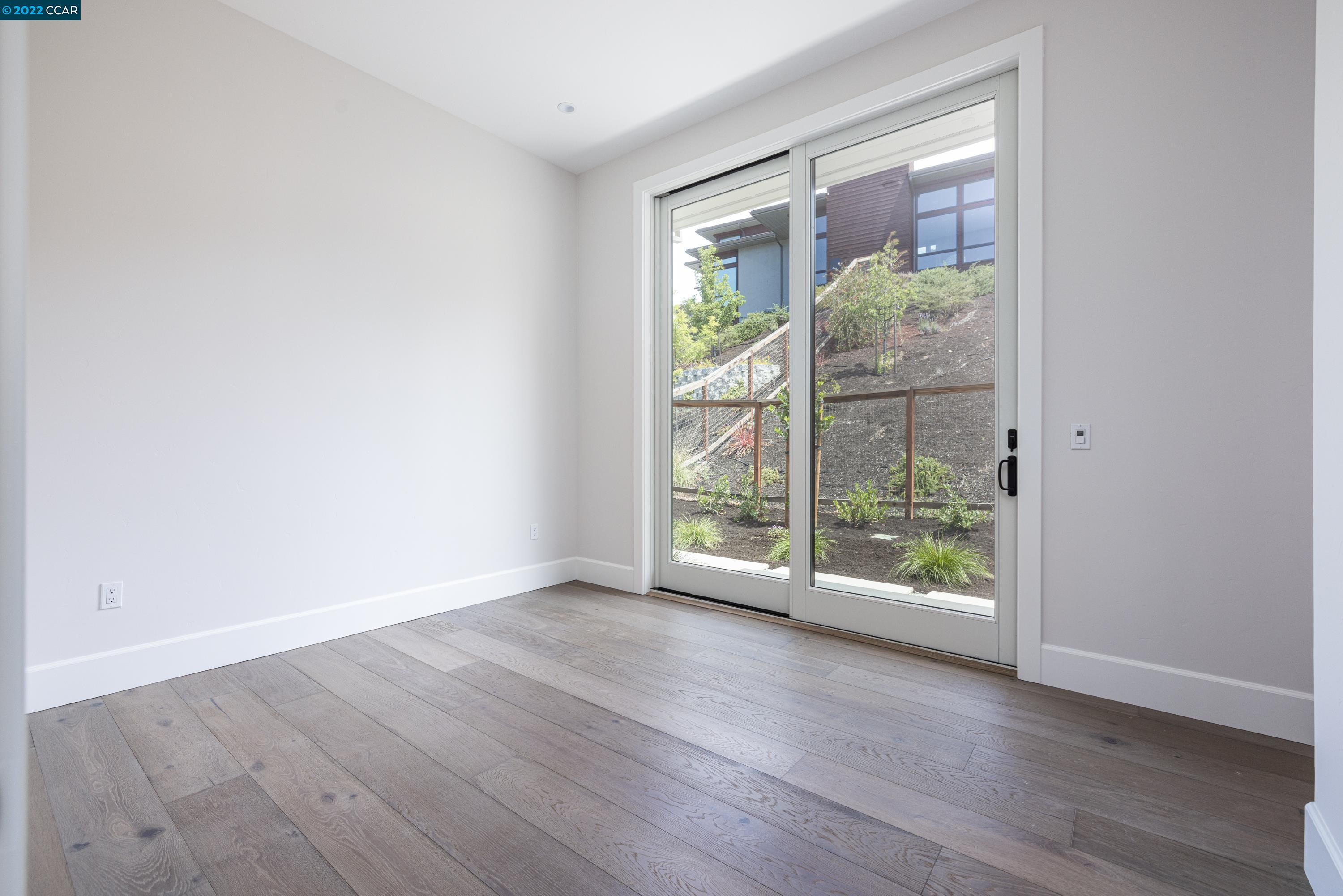 145 Arbor View Lane Lafayette, CA 94549 - Photo 21 of 46 an empty room with wooden floor and windows
