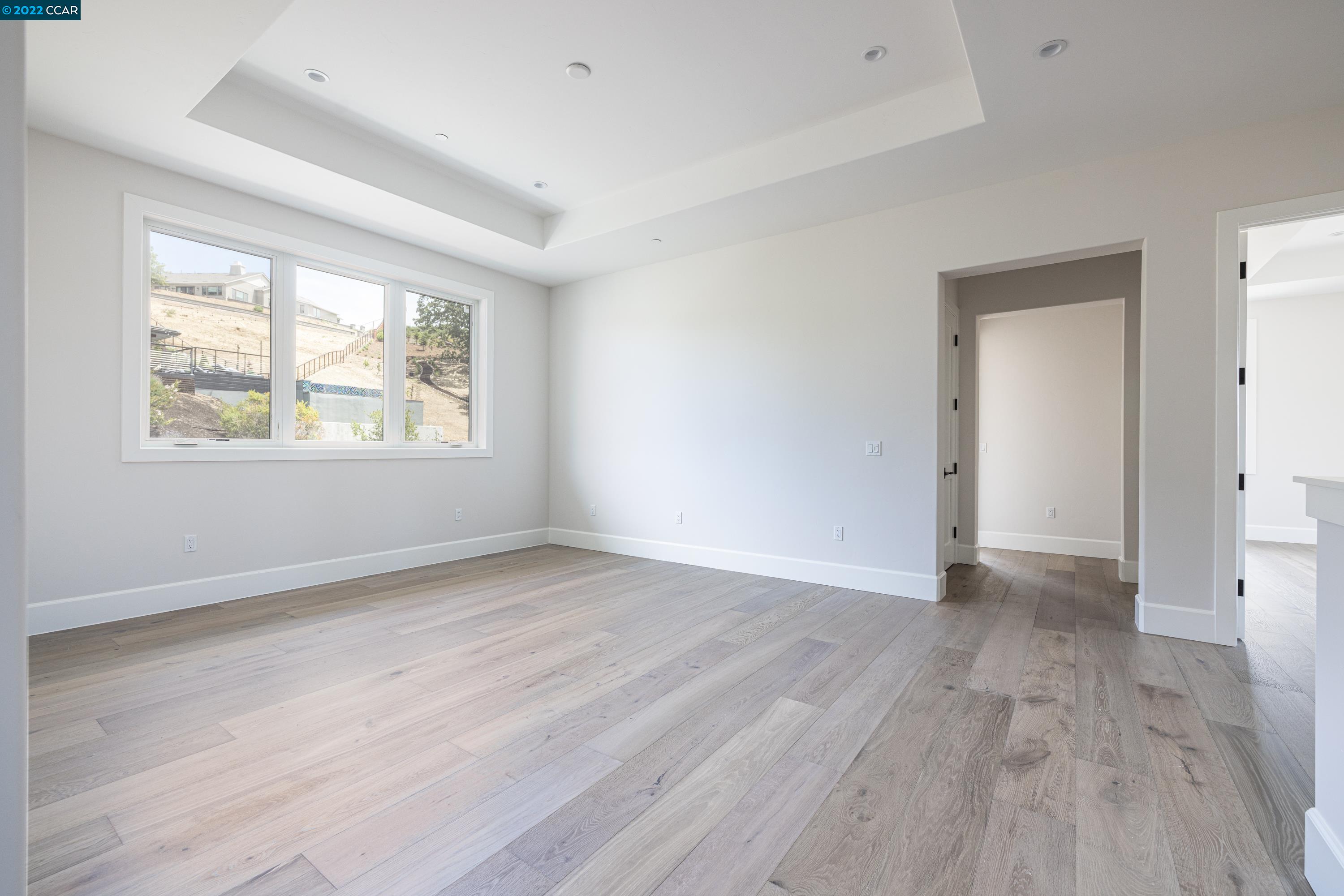 145 Arbor View Lane Lafayette, CA 94549 - Photo 27 of 46 an empty room with wooden floor and windows