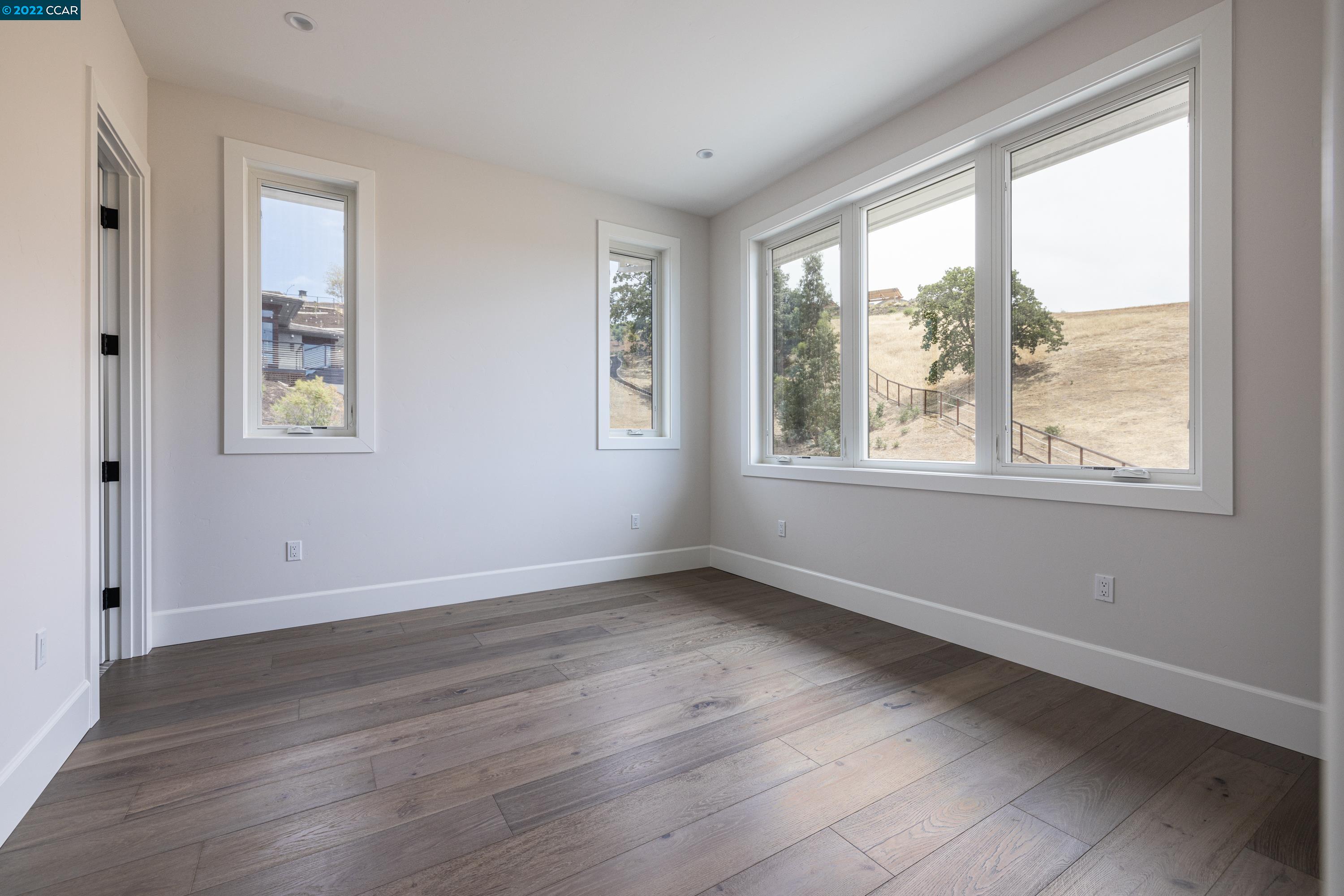 145 Arbor View Lane Lafayette, CA 94549 - Photo 33 of 46 an empty room with wooden floor and windows