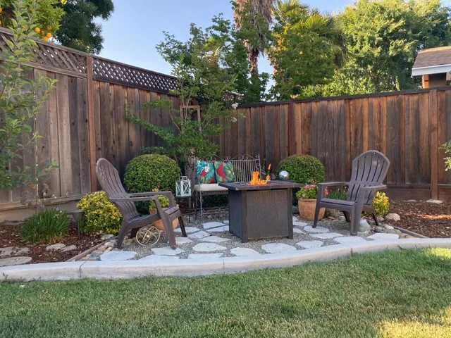 a view of a backyard with a patio outdoor dining space and plants