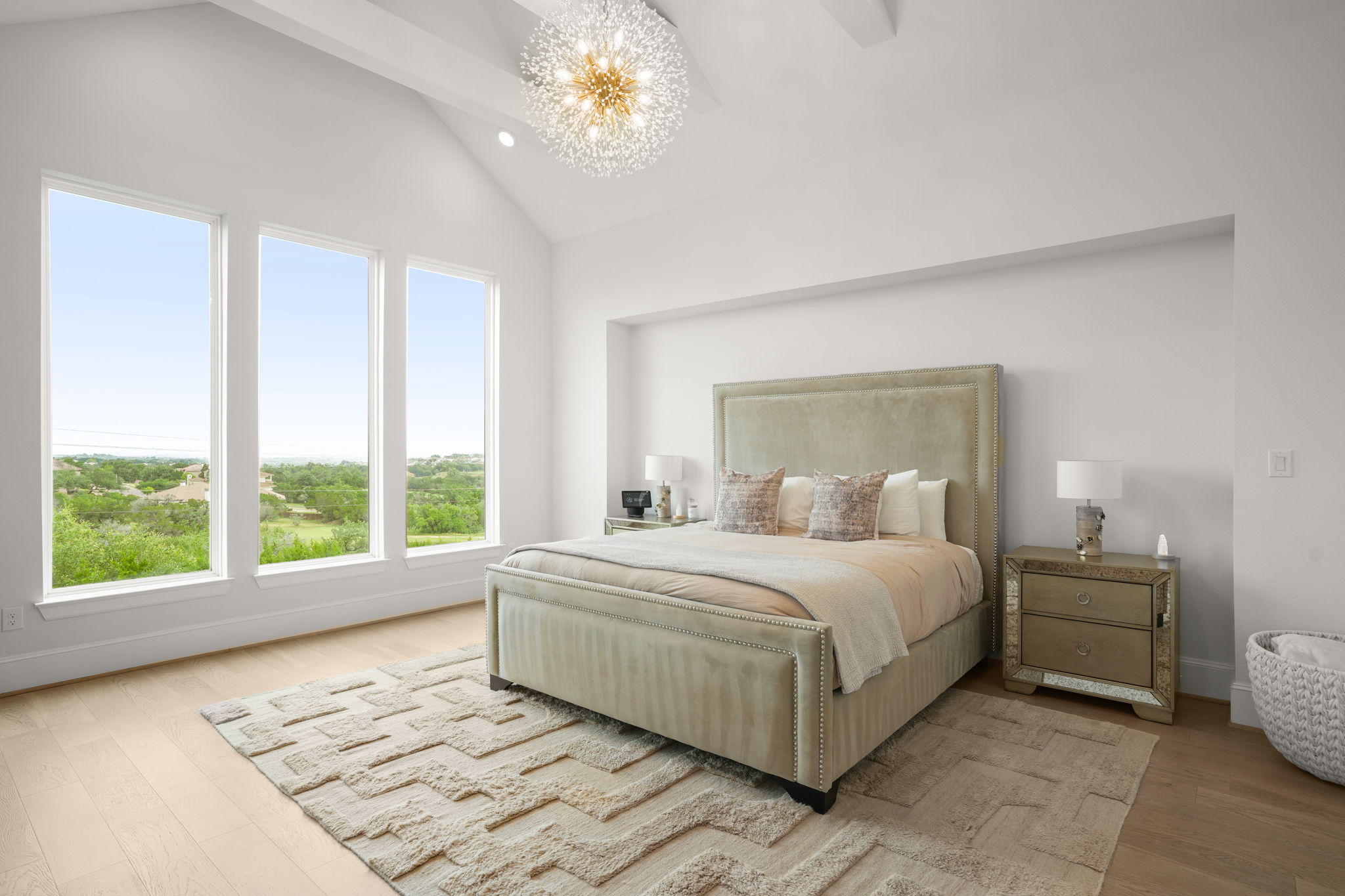 104 Lodestone Cove Austin, TX 78738 - Photo 16 of 40 Vaulted ceilings and wide plank flooring complement the peaceful view from this serene bedroom.