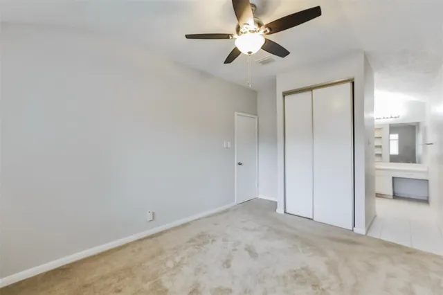 an empty room with fan and entrance