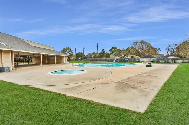 a view of a house with a yard and lake view