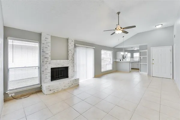 a view of a kitchen with an empty space and a fireplace
