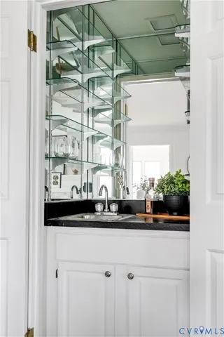 a sink with a window and a mirror