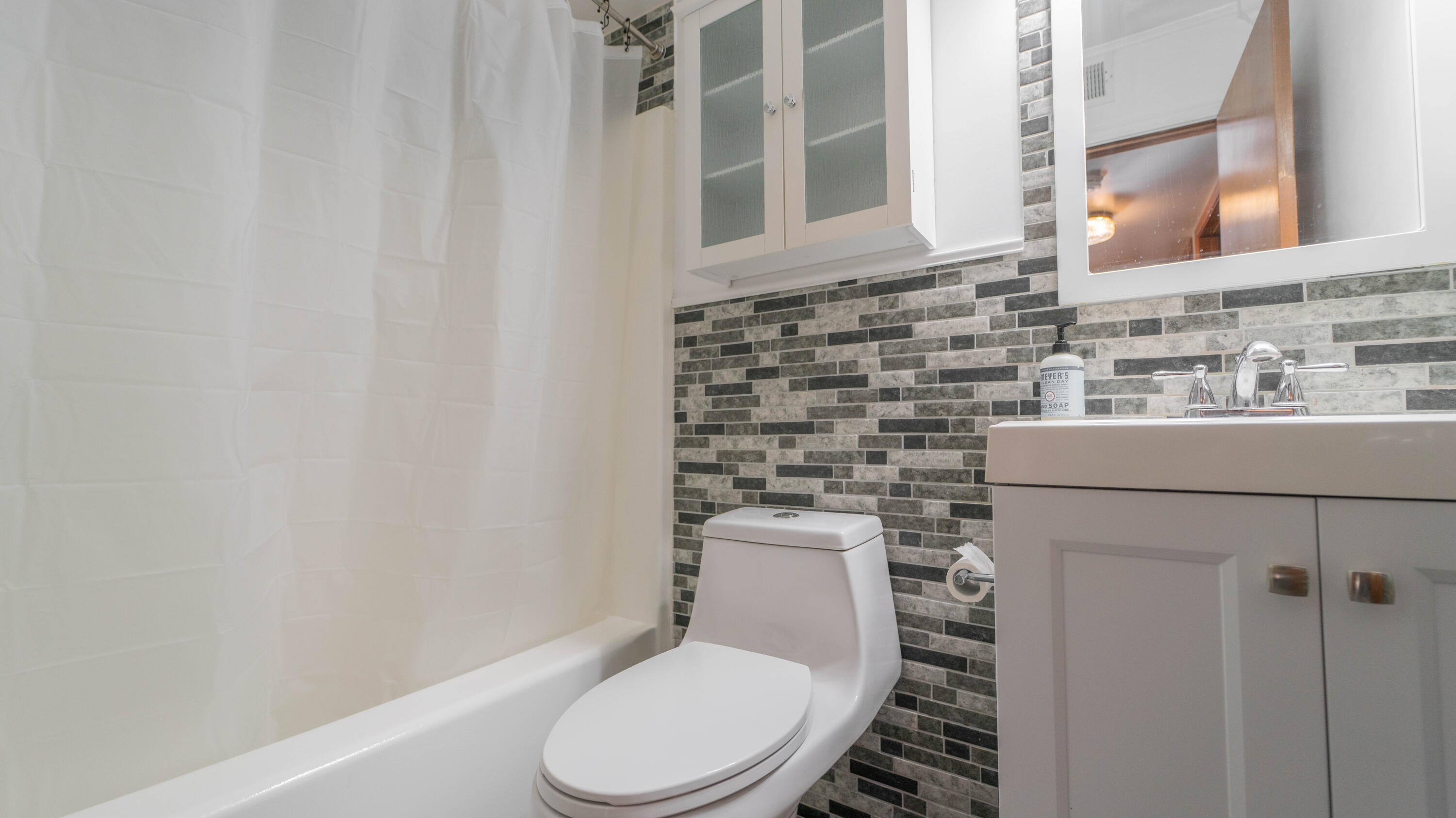 1069 Millpond Road, Unit E Valparaiso, IN 46385 - Photo 13 of 19 a white toilet sitting next to a bathroom sink