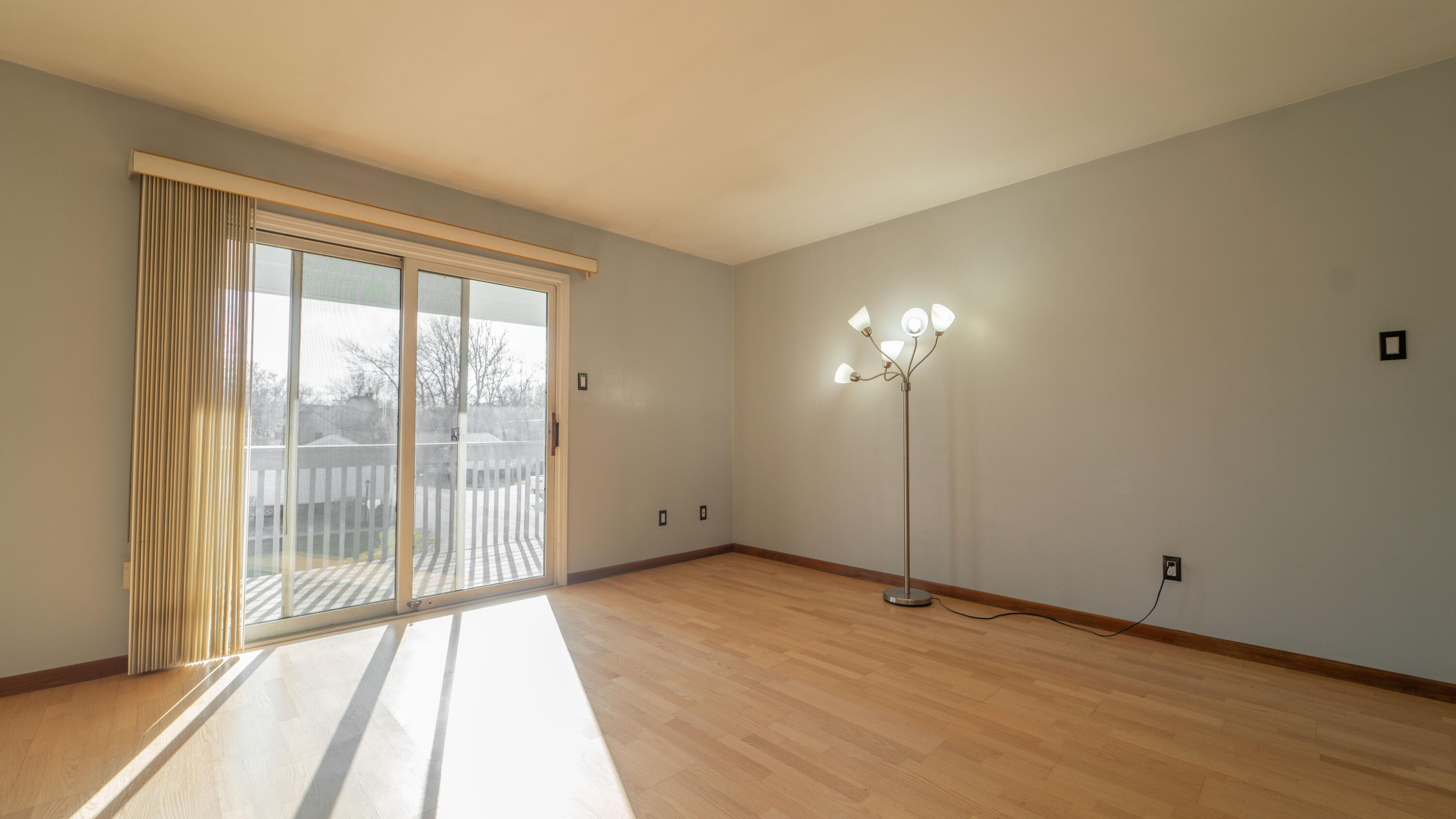 1069 Millpond Road, Unit E Valparaiso, IN 46385 - Photo 4 of 19 a view of an empty room with wooden floor and a window