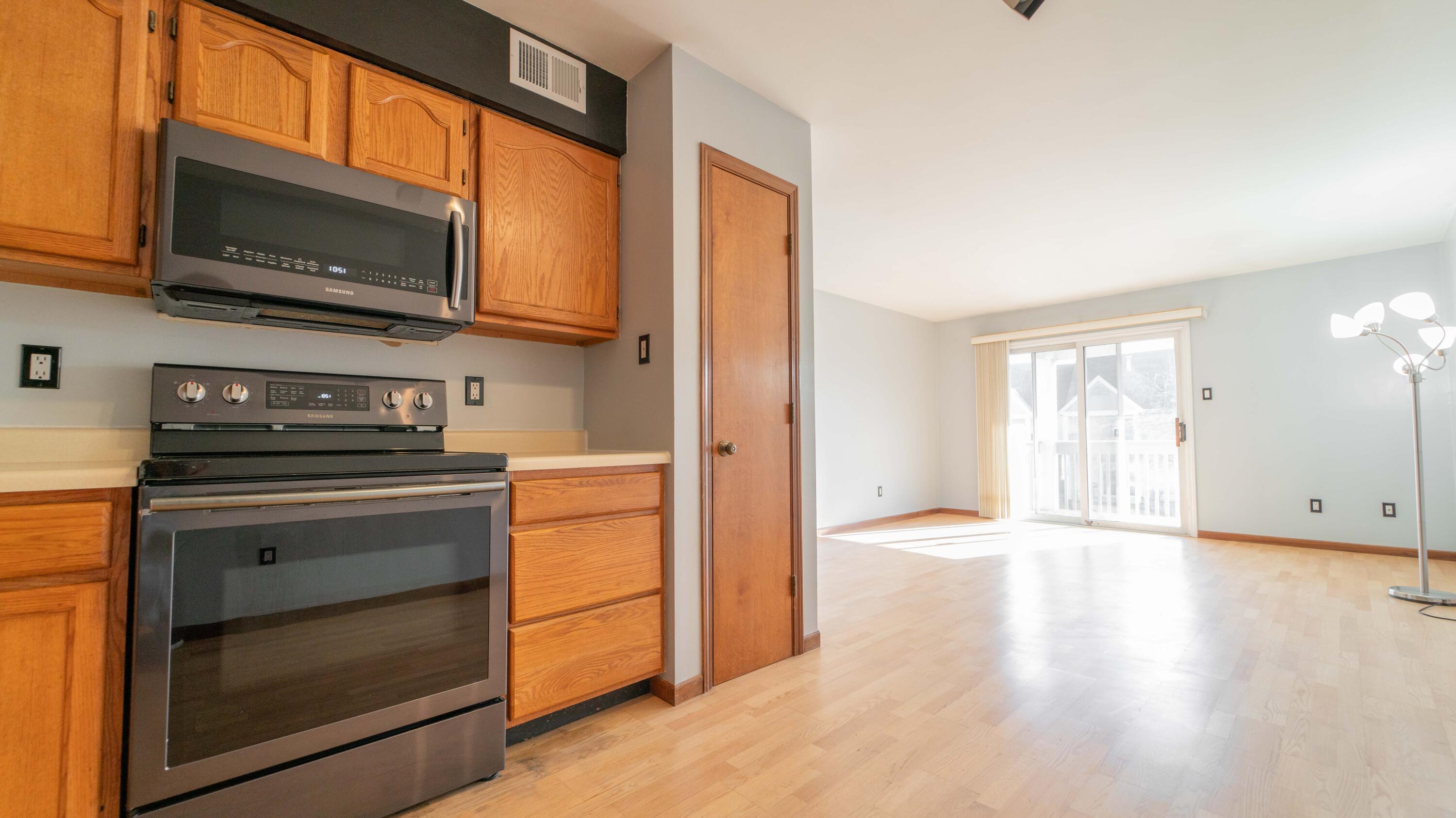 1069 Millpond Road, Unit E Valparaiso, IN 46385 - Photo 6 of 19 a kitchen with a stove microwave and sink