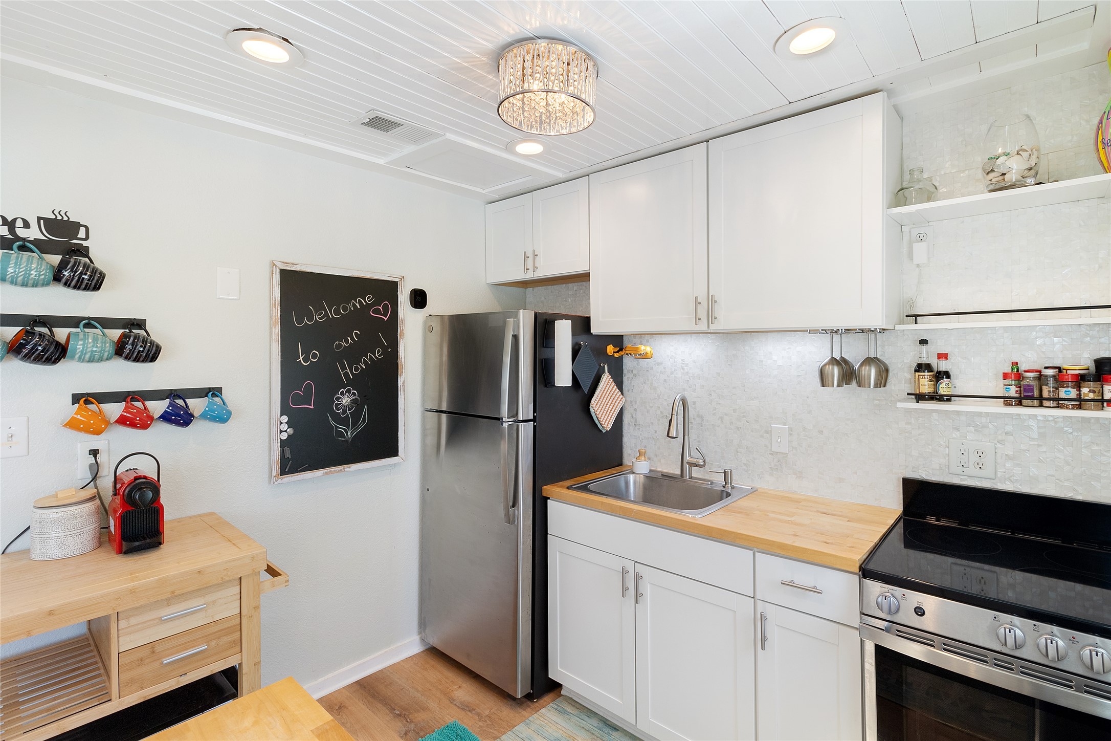 1010 Fort Velasco Drive Surfside Beach, TX 77541 - Photo 11 of 21 a kitchen with refrigerator and cabinets