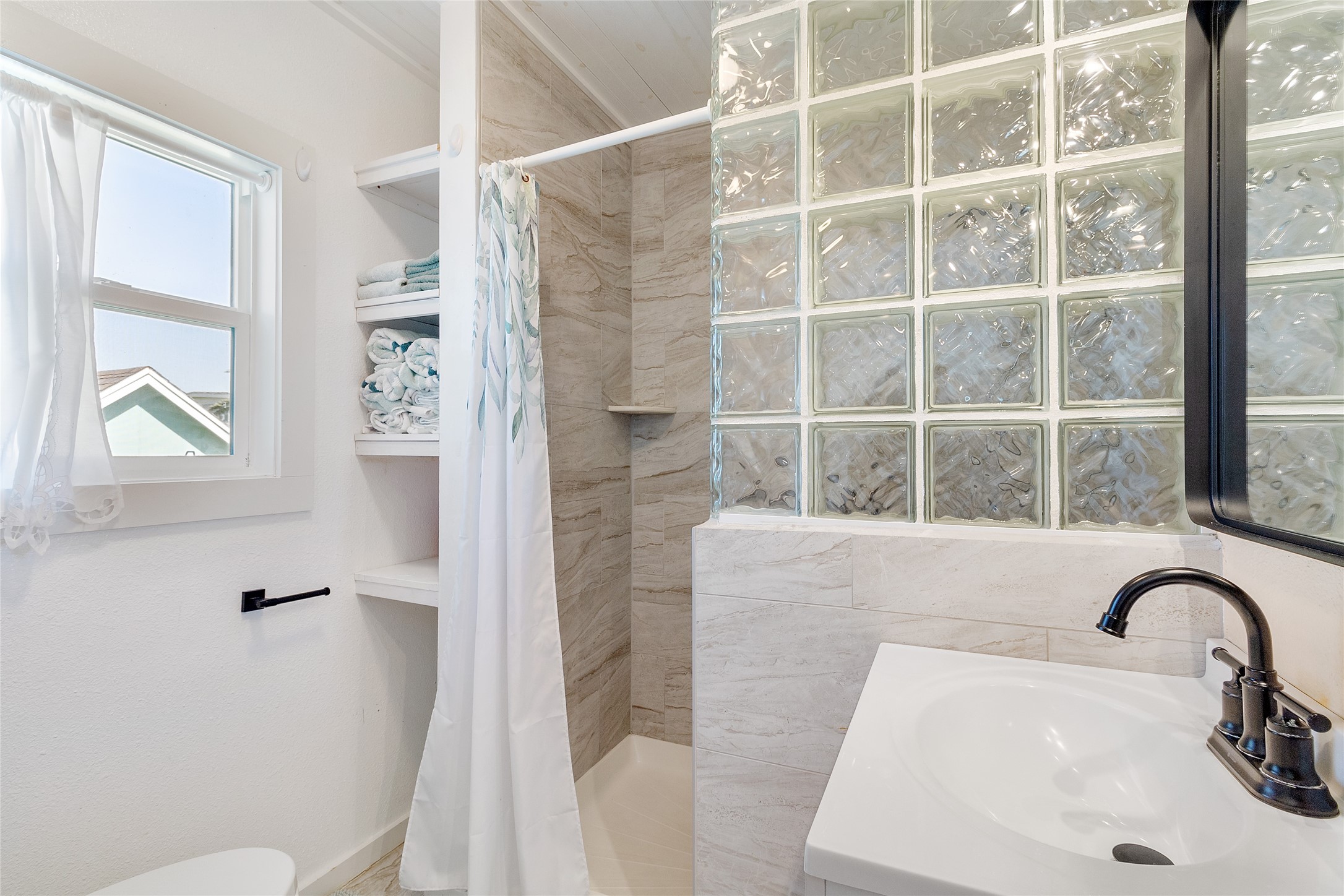 1010 Fort Velasco Drive Surfside Beach, TX 77541 - Photo 15 of 21 a bathroom with a sink a toilet and a shower