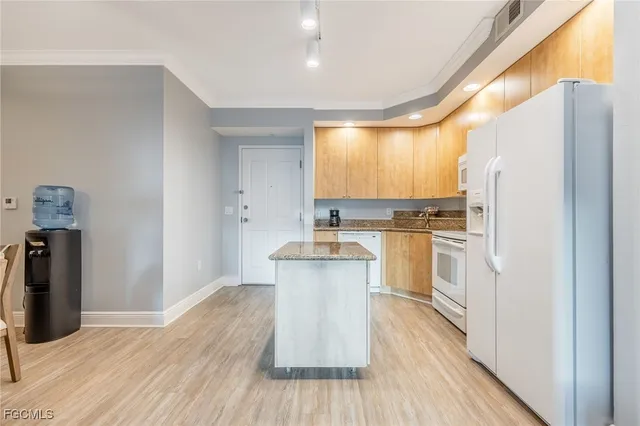 a kitchen with a refrigerator and a stove
