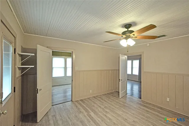 an empty room with wooden floor and door