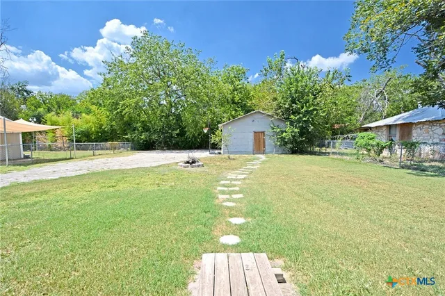 a view of an house with backyard space and balcony