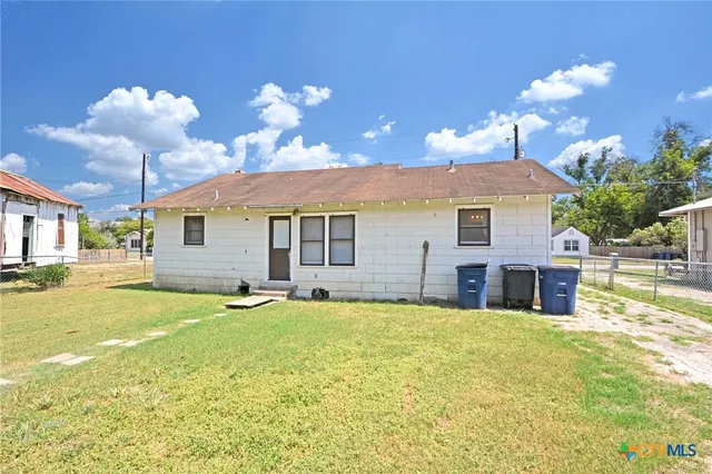 a view of a house with a yard and swimming pool