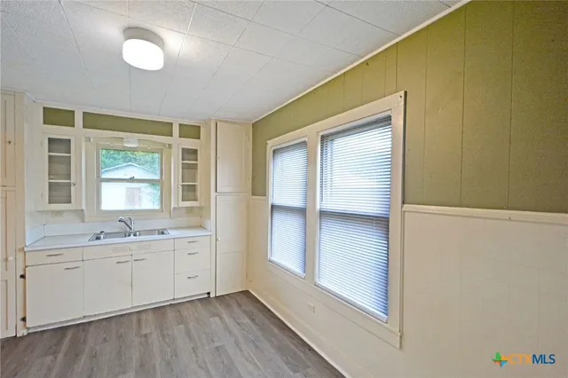 a view of cabinets and wooden floor