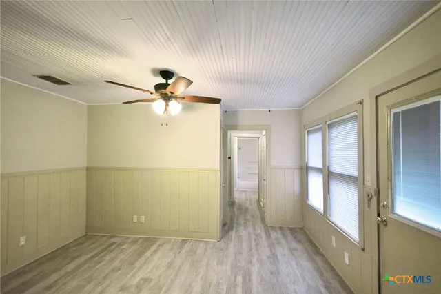 wooden floor in an empty room with a window