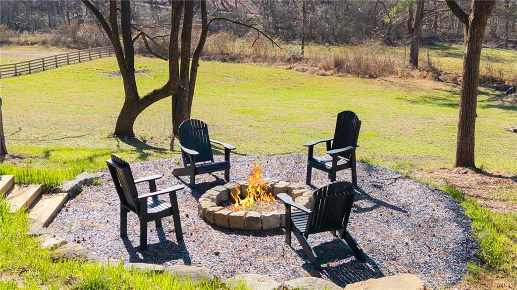 1783 4 Mile Church Road Ball Ground, GA 30107 - Photo 12 of 60 a view of swimming pool with chairs and table under an umbrella