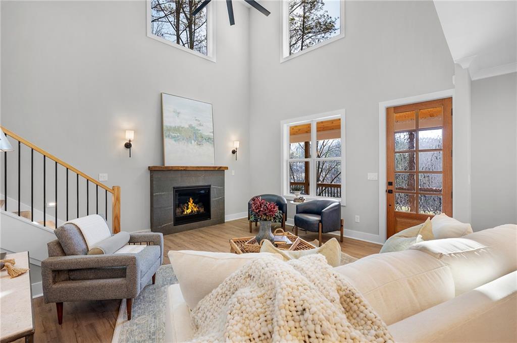 1783 4 Mile Church Road Ball Ground, GA 30107 - Photo 22 of 60 a living room with furniture a fireplace and a large window