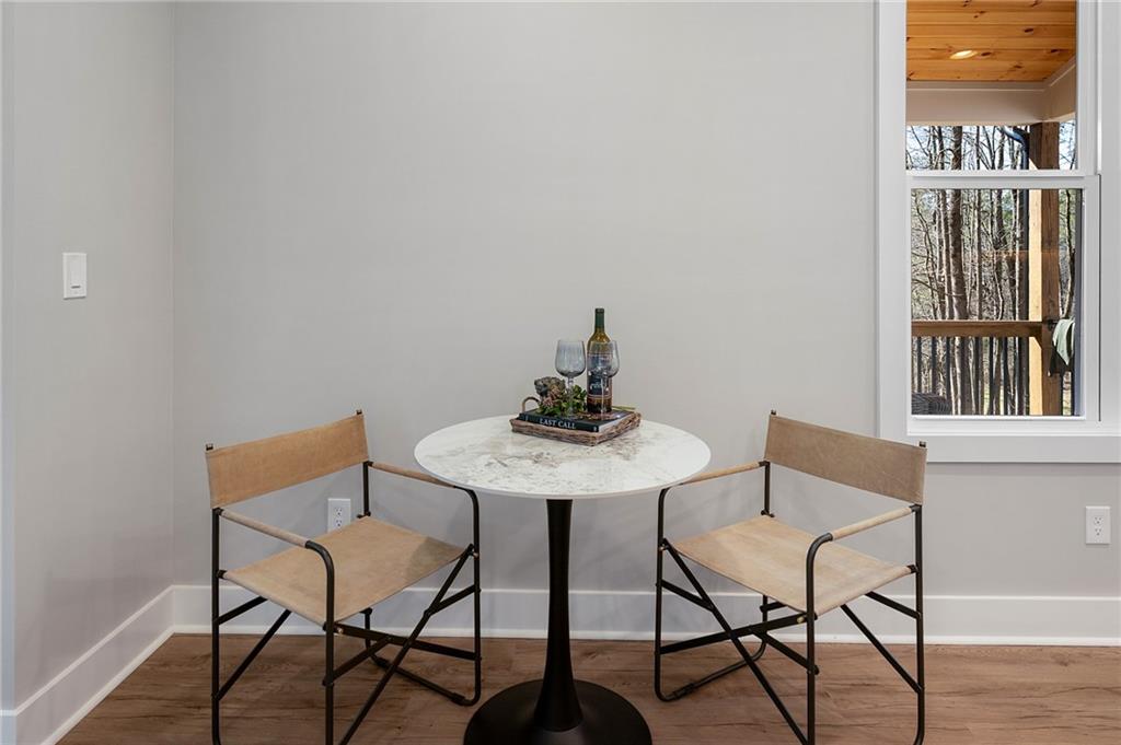1783 4 Mile Church Road Ball Ground, GA 30107 - Photo 28 of 60 a view of a dining room with furniture and wooden floor