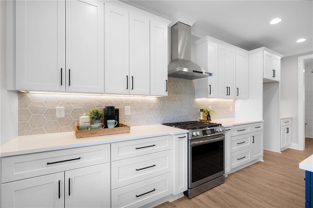 1783 4 Mile Church Road Ball Ground, GA 30107 - Photo 30 of 60 a kitchen with stainless steel appliances white cabinets and a stove top oven