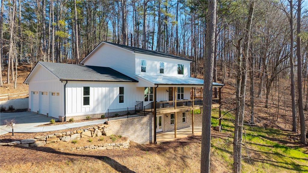 1783 4 Mile Church Road Ball Ground, GA 30107 - Photo 3 of 60 a front view of a house with garden
