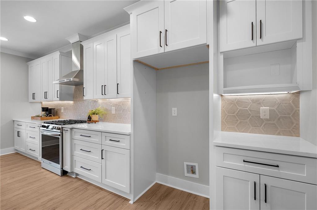 1783 4 Mile Church Road Ball Ground, GA 30107 - Photo 32 of 60 a kitchen with white cabinets and appliances