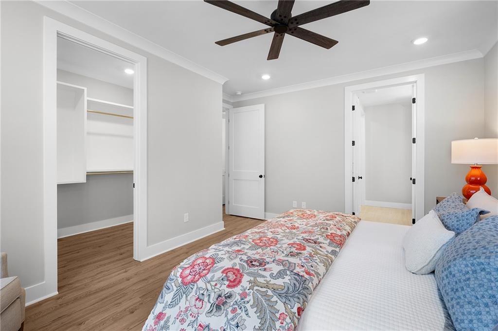 1783 4 Mile Church Road Ball Ground, GA 30107 - Photo 40 of 60 a bedroom with a bed and a chandelier