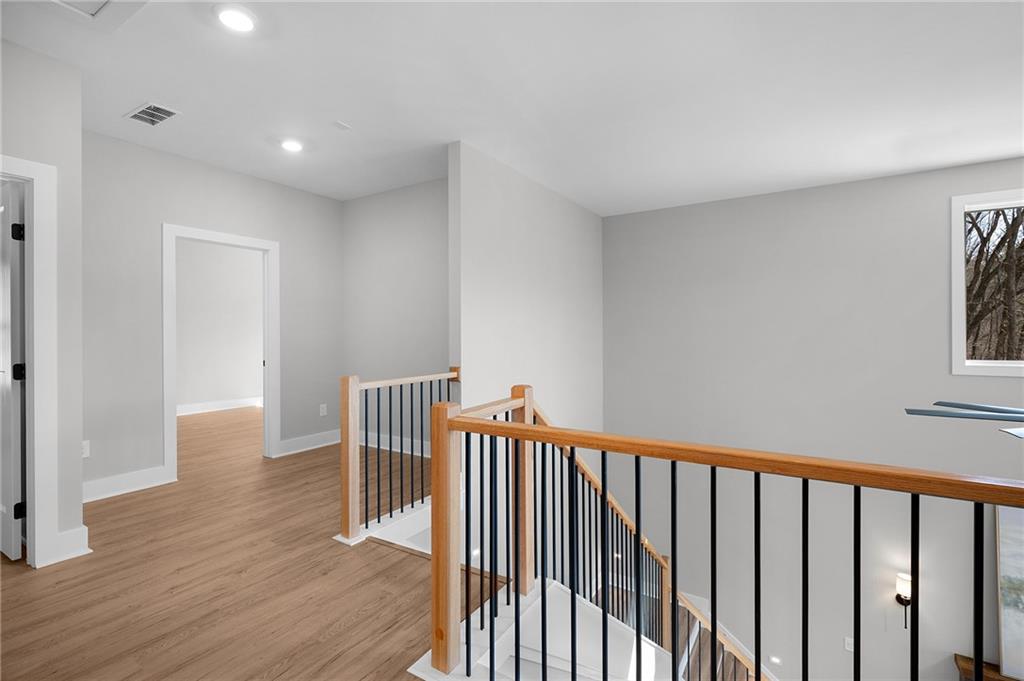 1783 4 Mile Church Road Ball Ground, GA 30107 - Photo 44 of 60 a view of a hallway with wooden floor and windows
