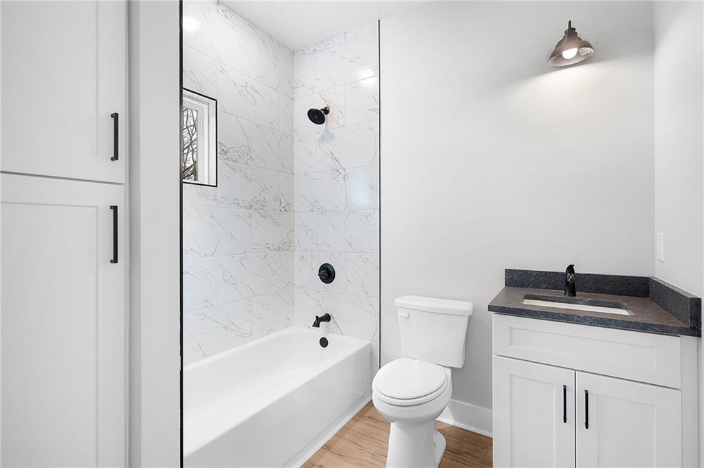 1783 4 Mile Church Road Ball Ground, GA 30107 - Photo 48 of 60 a bathroom with a granite countertop sink toilet and shower