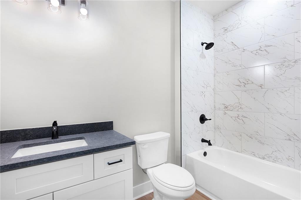 1783 4 Mile Church Road Ball Ground, GA 30107 - Photo 51 of 60 a bathroom with a granite countertop sink a toilet and shower