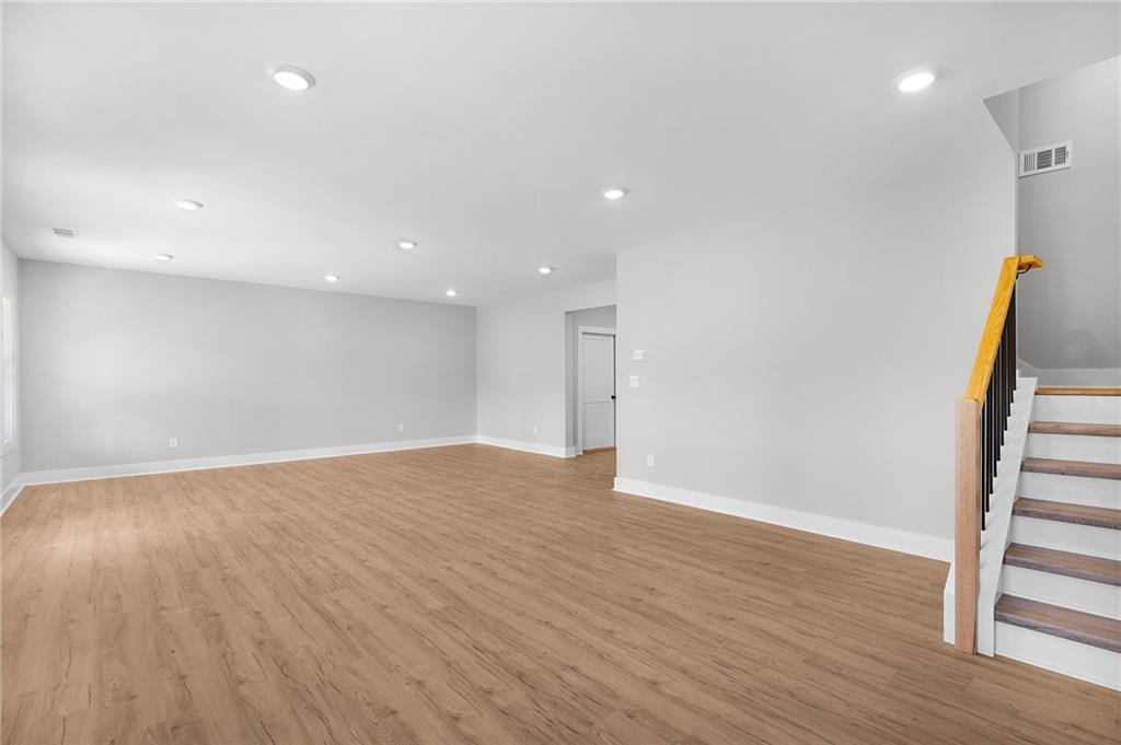 1783 4 Mile Church Road Ball Ground, GA 30107 - Photo 55 of 60 a view of an empty room with wooden floor and stairs