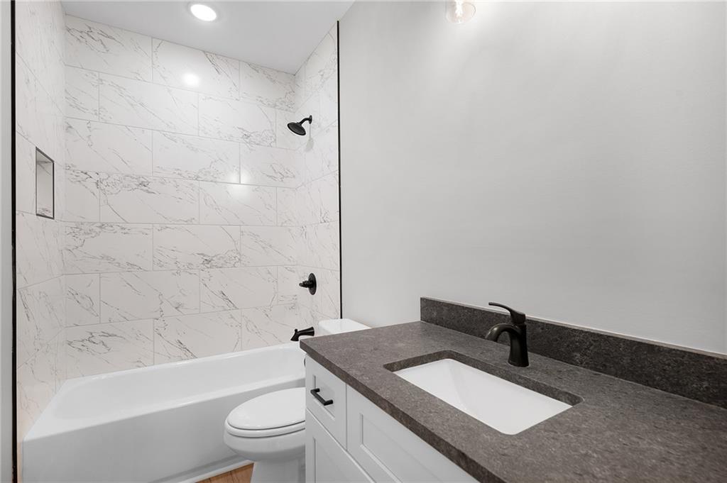 1783 4 Mile Church Road Ball Ground, GA 30107 - Photo 57 of 60 a bathroom with a granite countertop sink mirror toilet and bathtub