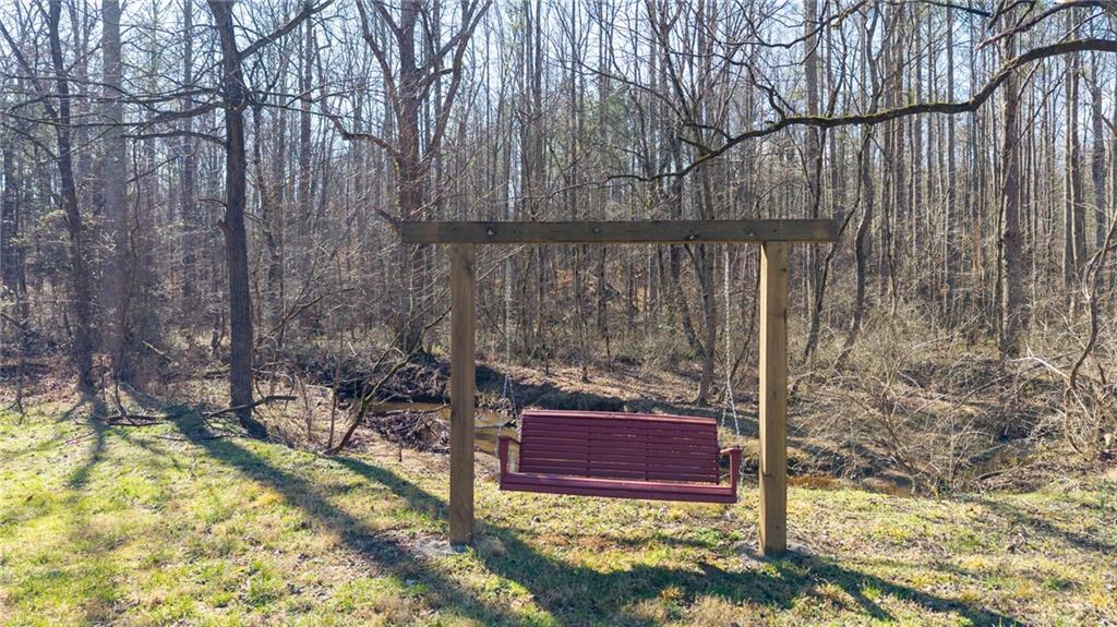 1783 4 Mile Church Road Ball Ground, GA 30107 - Photo 9 of 60 a view of a backyard with a trees