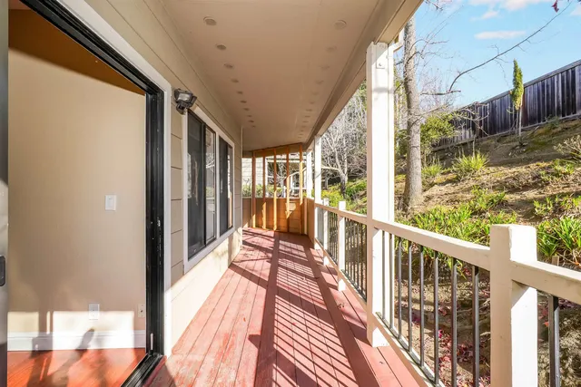a view of balcony with wooden floor