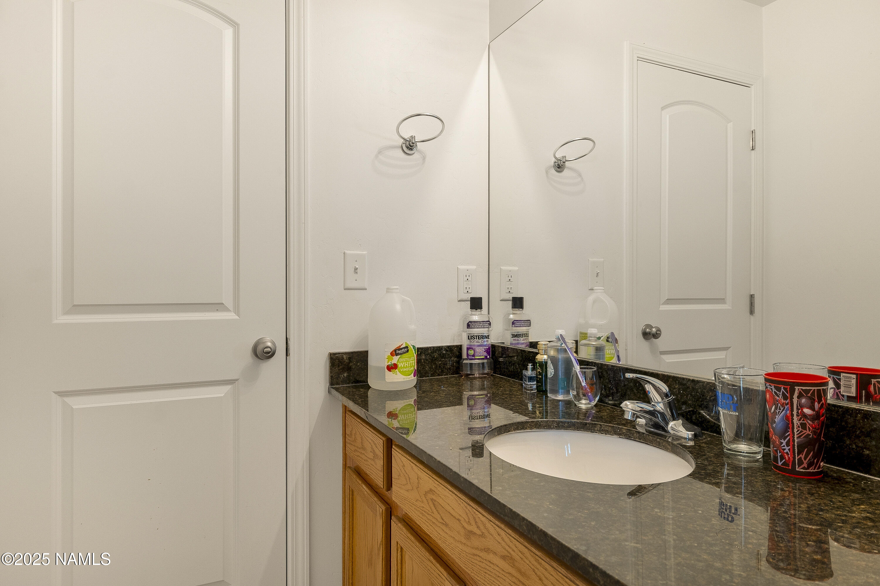 12361 Pegasus Road Bellemont, AZ 86015 - Photo 13 of 18 a bathroom with a sink and a mirror