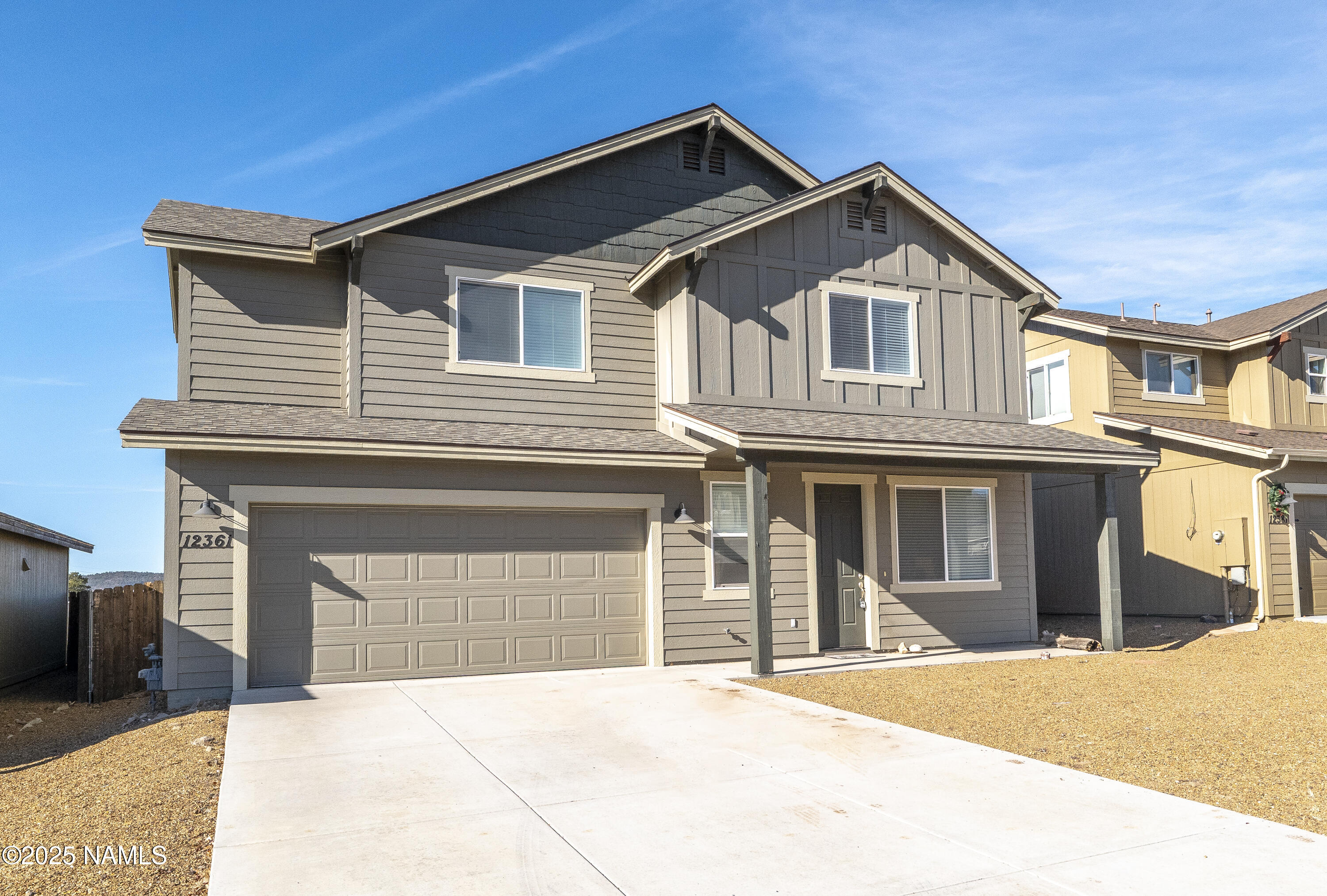 12361 Pegasus Road Bellemont, AZ 86015 - Photo 18 of 18 a front view of a house with a yard and garage