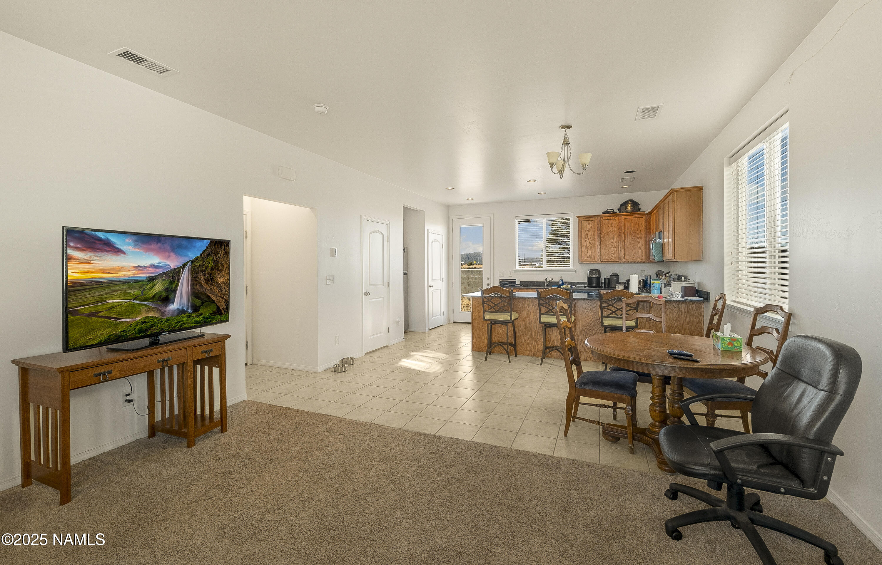 12361 Pegasus Road Bellemont, AZ 86015 - Photo 3 of 18 a view of a livingroom with furniture and a flat screen tv