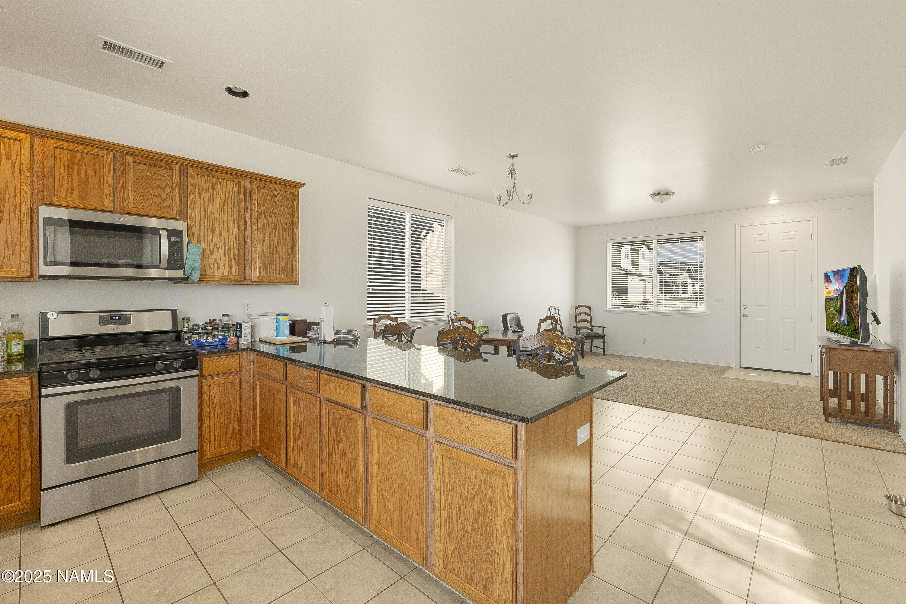 12361 Pegasus Road Bellemont, AZ 86015 - Photo 4 of 18 a kitchen with stainless steel appliances granite countertop a sink and cabinets