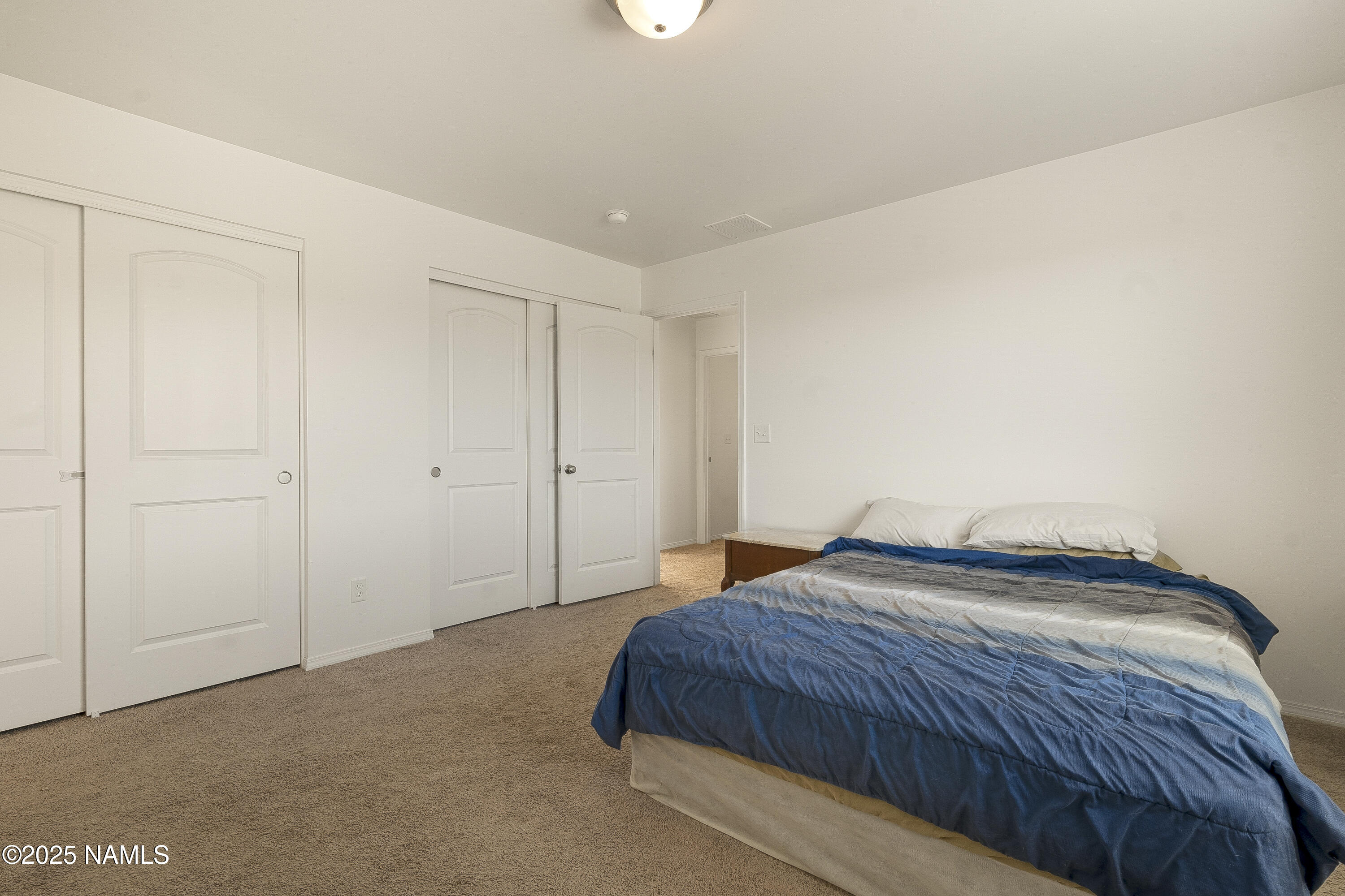 12361 Pegasus Road Bellemont, AZ 86015 - Photo 8 of 18 a bedroom with a bed and a closet
