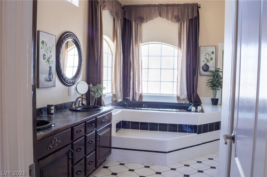 2775 Taylor Street Logandale, NV 89021 - Photo 7 of 41 This primary bathroom offers a spacious layout featuring a soaking tub and elegant vanity.
